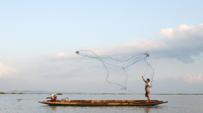 A fisher casts a net