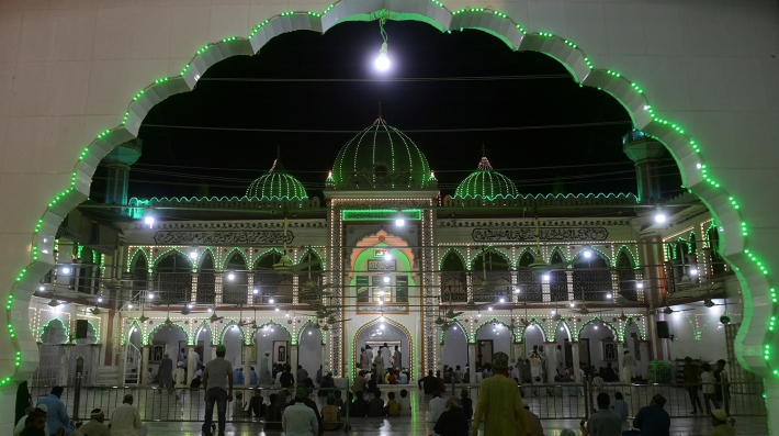 People in a mosque at night 