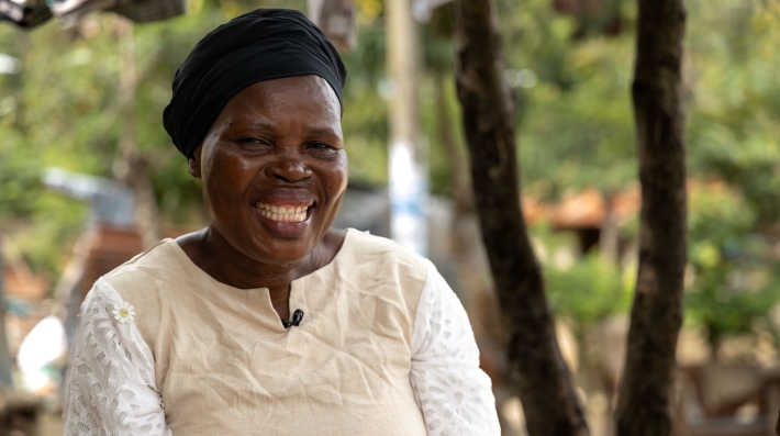 A woman smiles at the camera