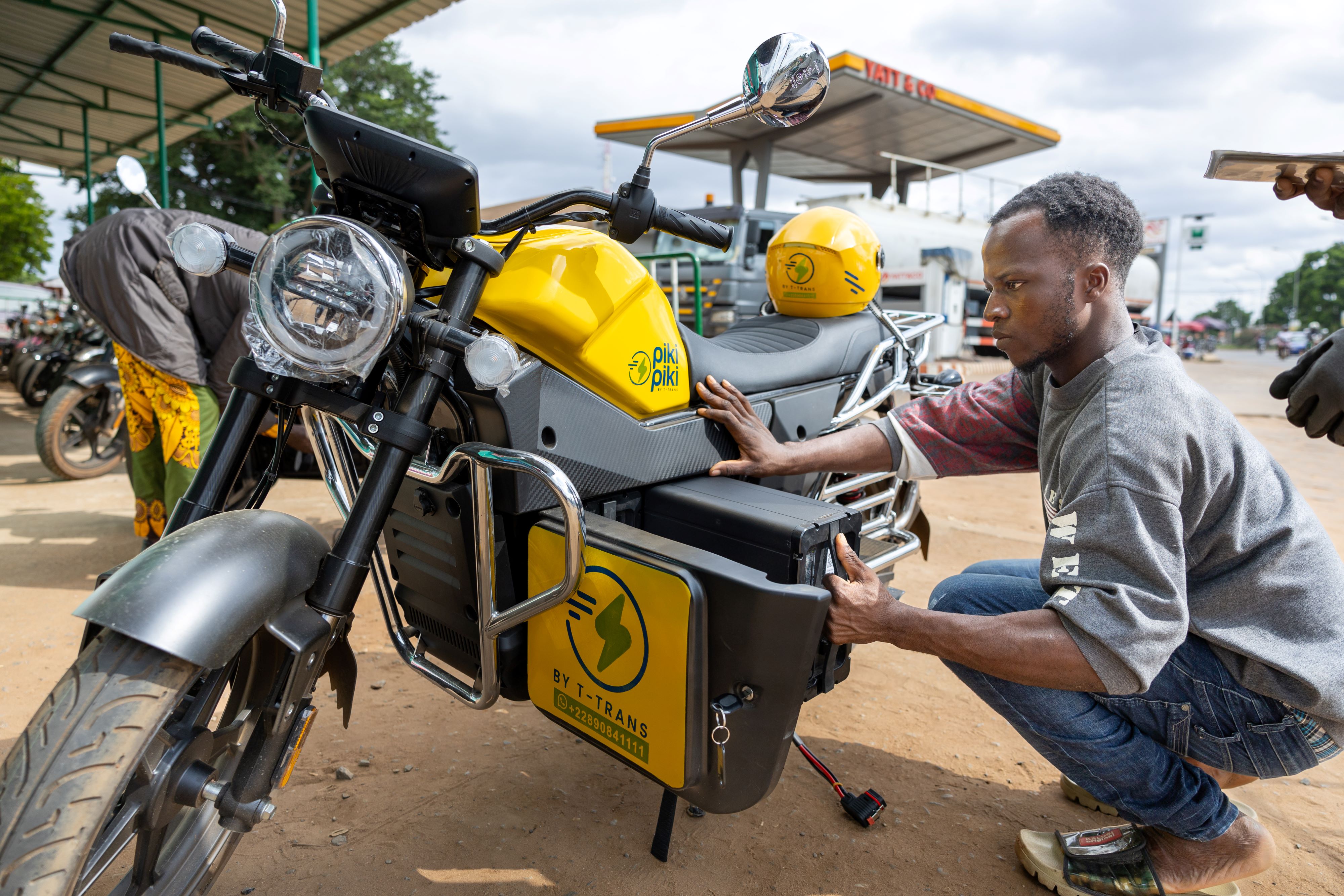 A rider examines his electric taxi bike which he uses for business in Lome,Togo