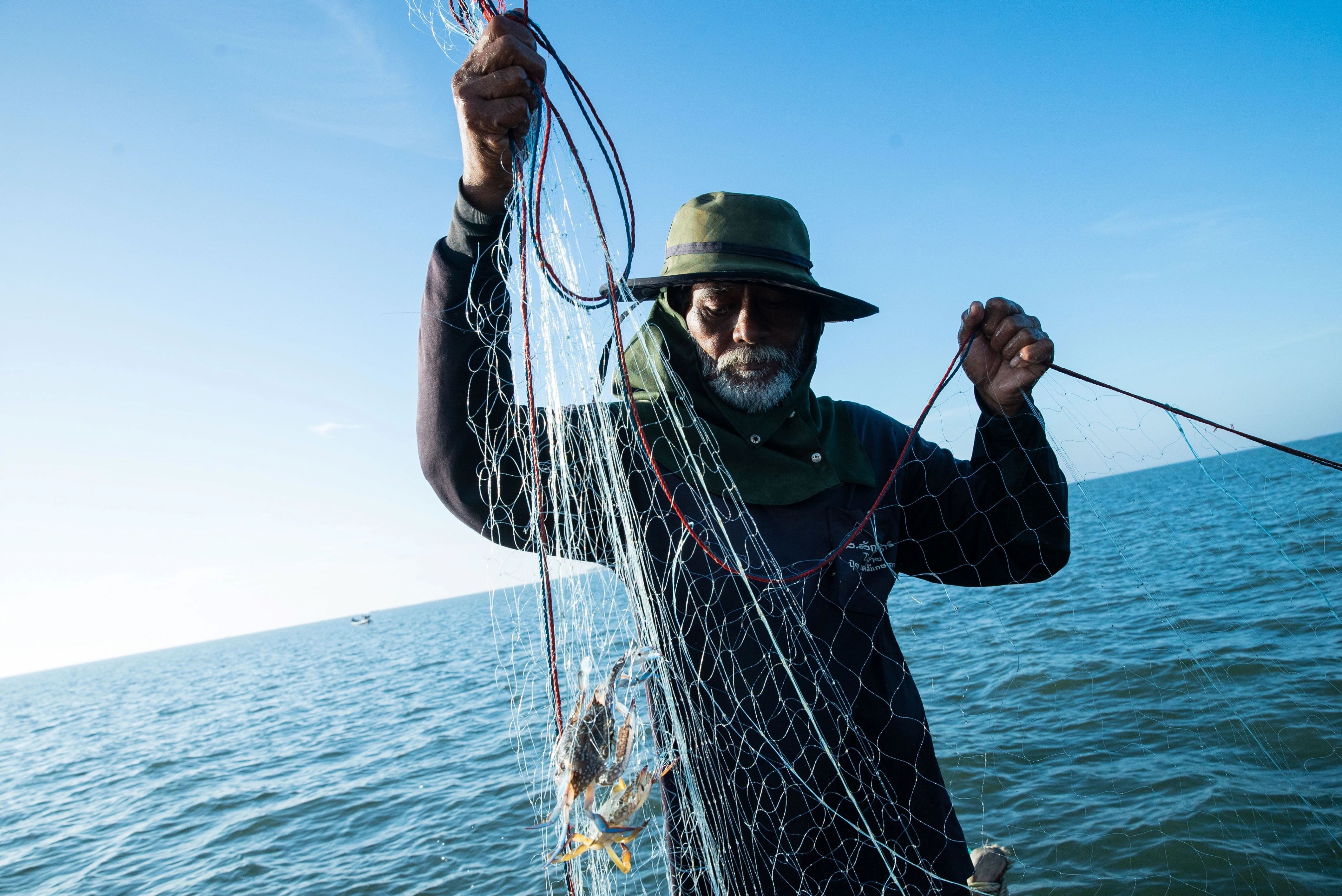  Sutham Abmanee , pulls in blue swimming crab in an area of the Gulf of Thailand designated as a "refugia"