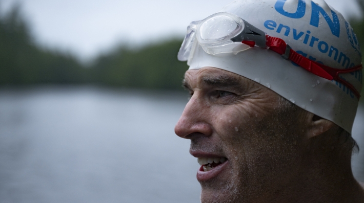 A man in a UNEP-branded swimming cap