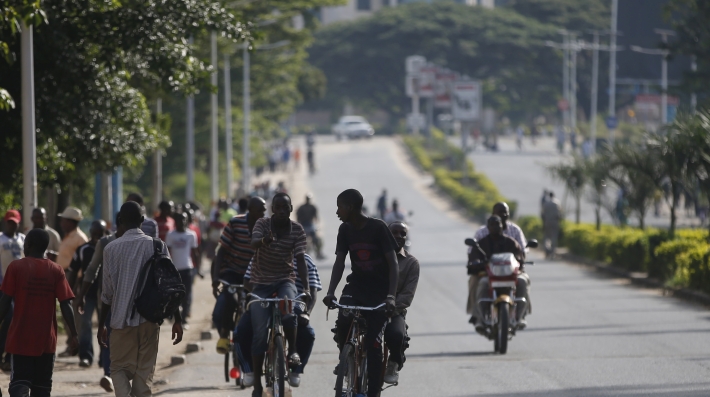 Pedestrians and cyclists on a tree-lined street